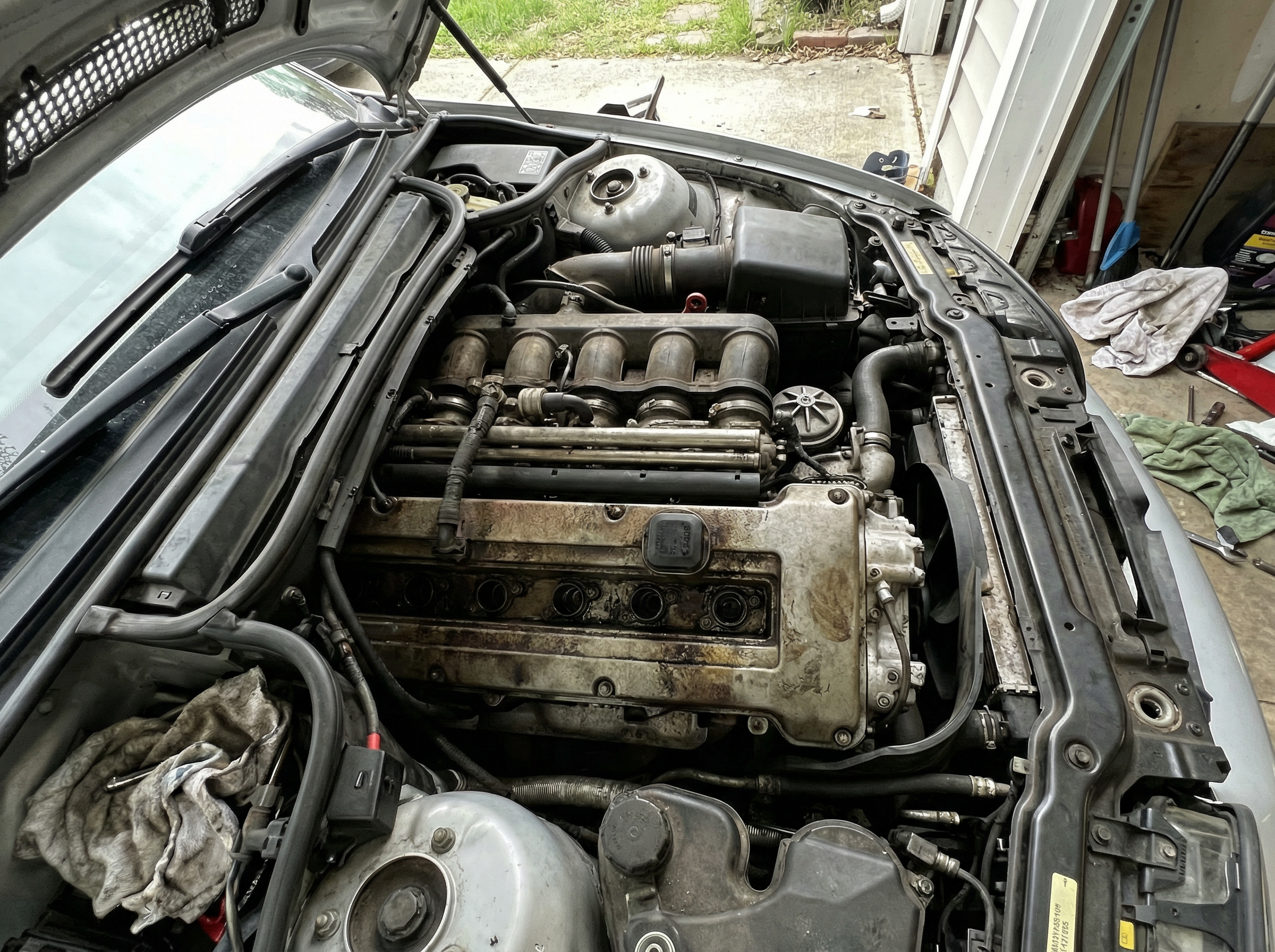 BMW E46 M3 engine bay before dry ice blasting — grease and grime on S54