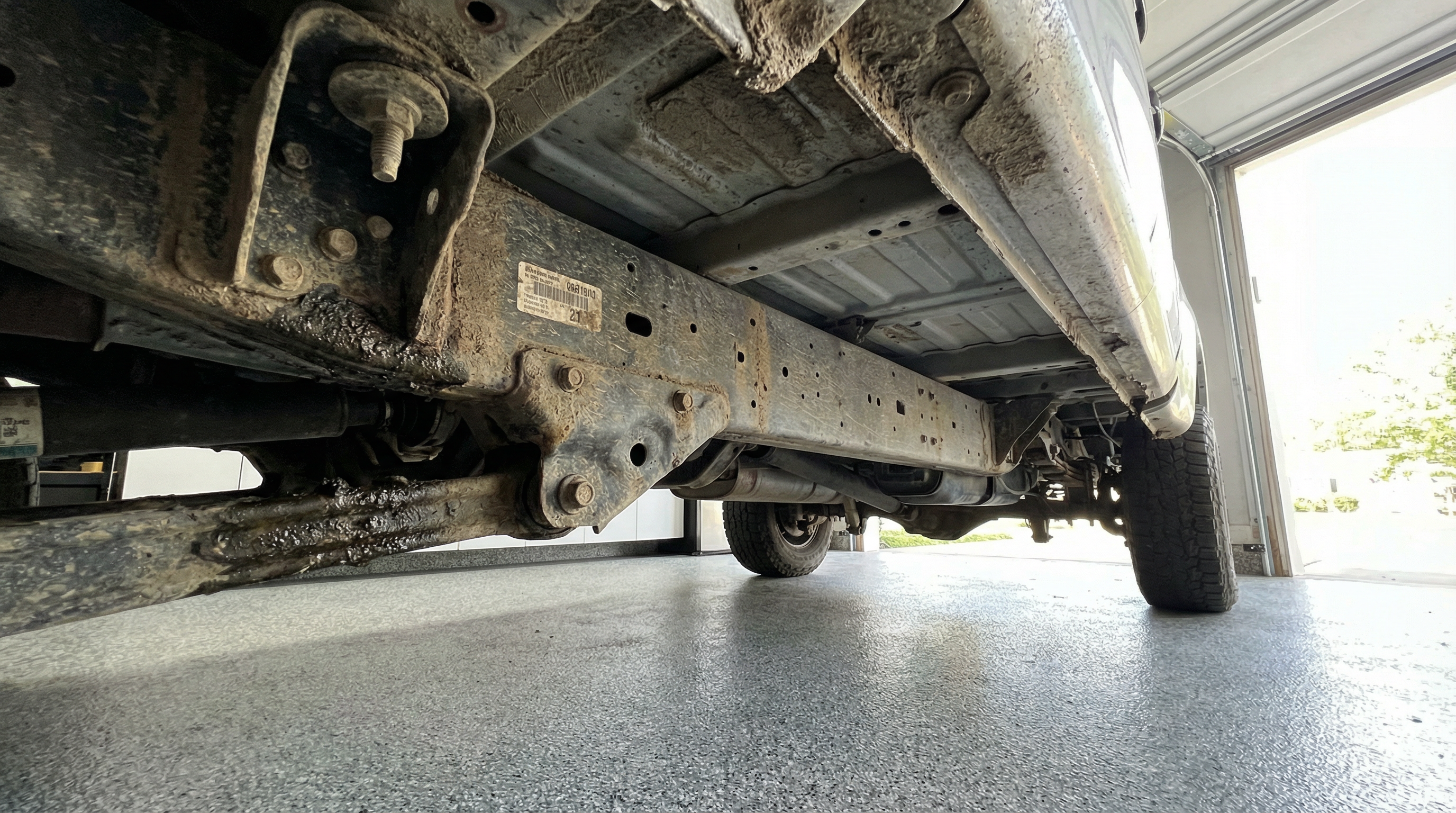 Ford F-250 underbody before dry ice blasting — caked grease and years of road grime